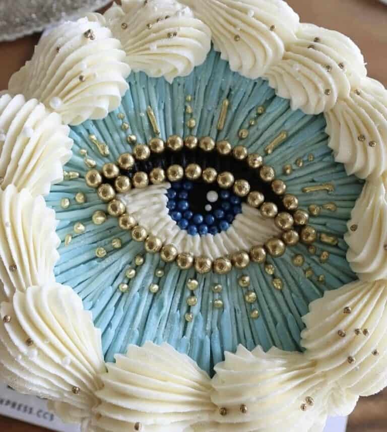 screenshot Eye-themed cake with blue and gold decorations.