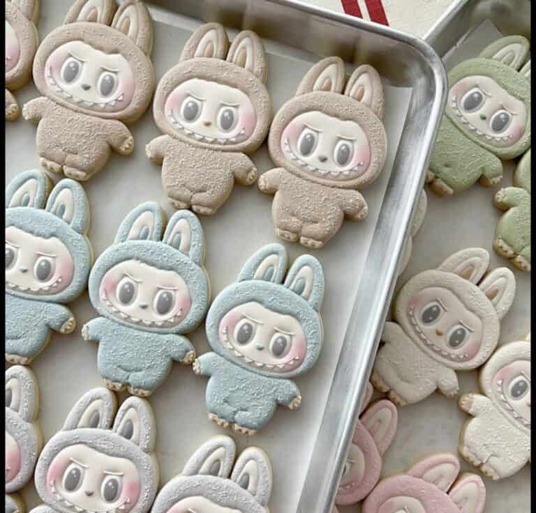 screenshot Colorful bunny-shaped cookies on baking tray.