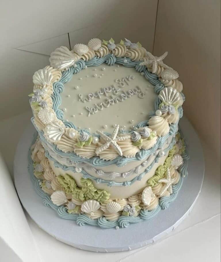 beach baby vintage cake Beach-themed cake with shells and starfish decorations.