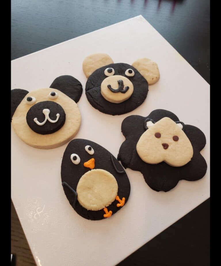 cut out cookies Animal-shaped cookies on white surface.