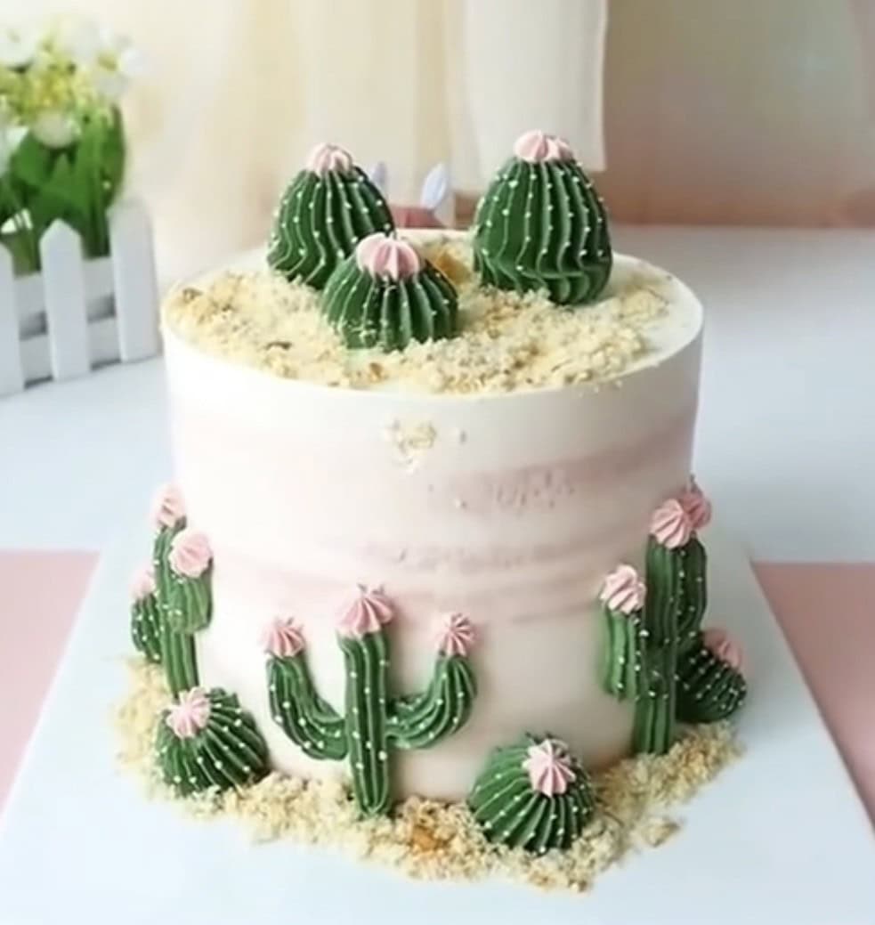 Cake decorated with cactus buttercream icing.