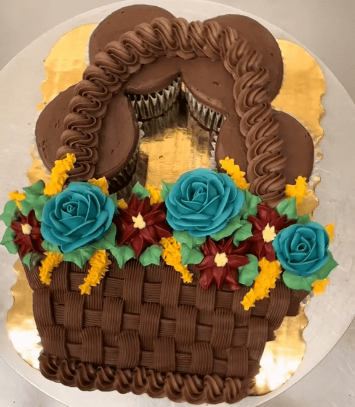 Cupcake basket with colorful flower decorations.