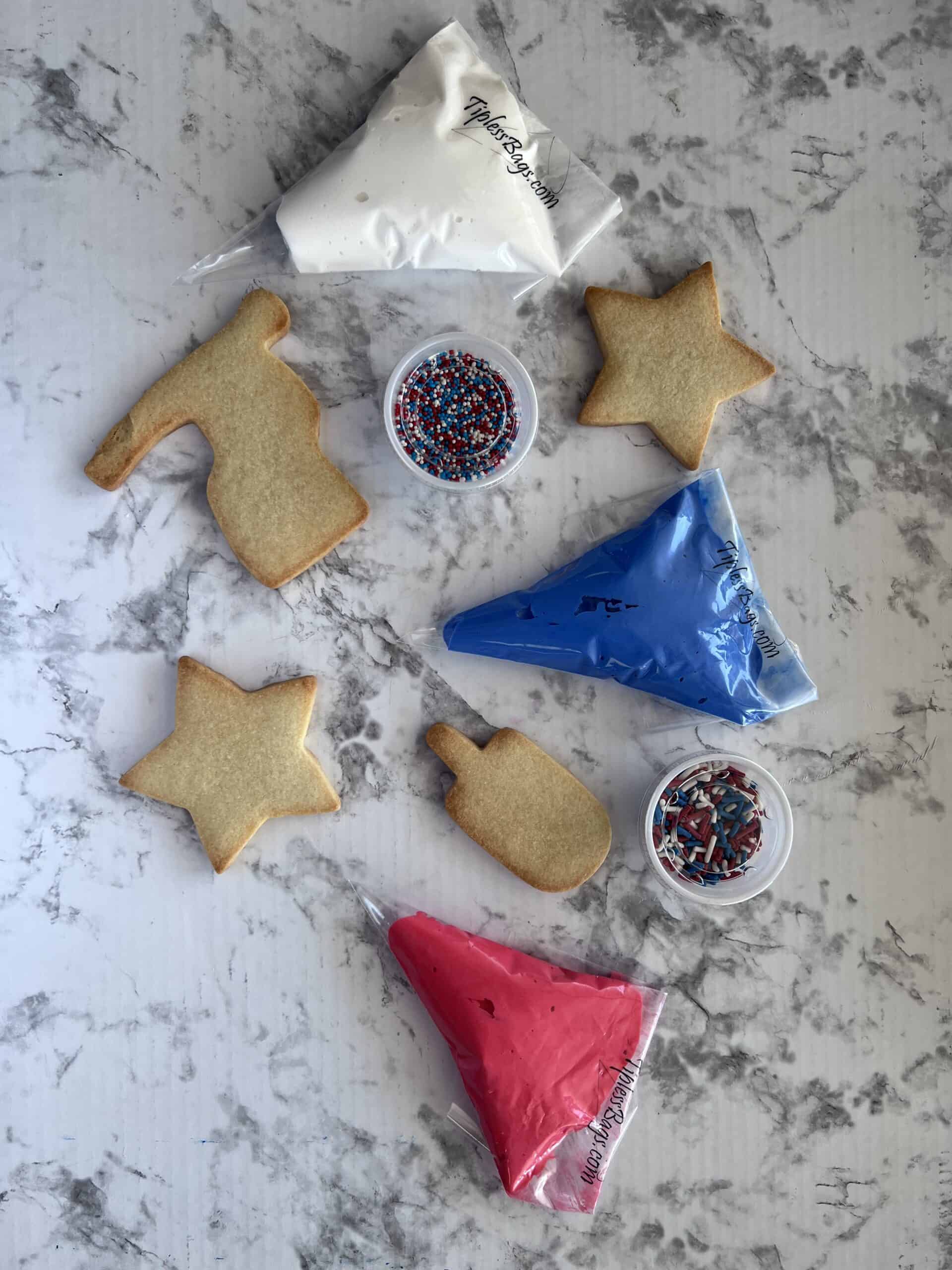 Cookies with frosting bags and sprinkles for decoration.