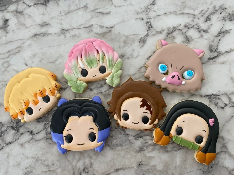 Cute character cookies on a marble countertop.