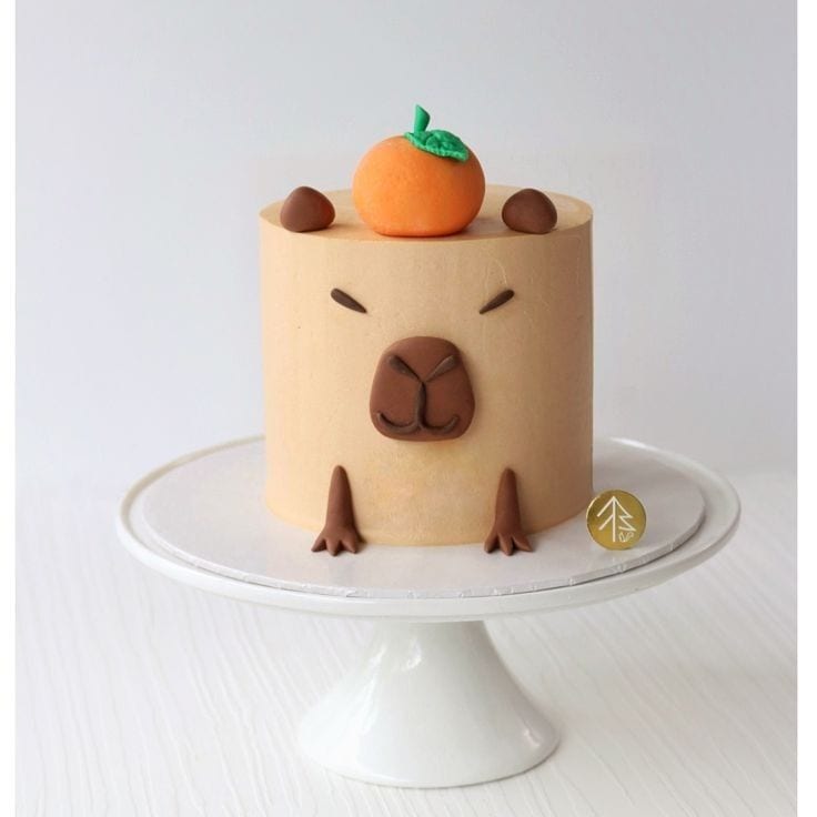 kids camp capybara cake Capybara-themed cake with orange on top