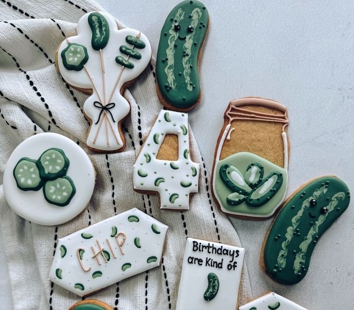 pickle cookies Cucumber-themed decorated cookies on cloth.