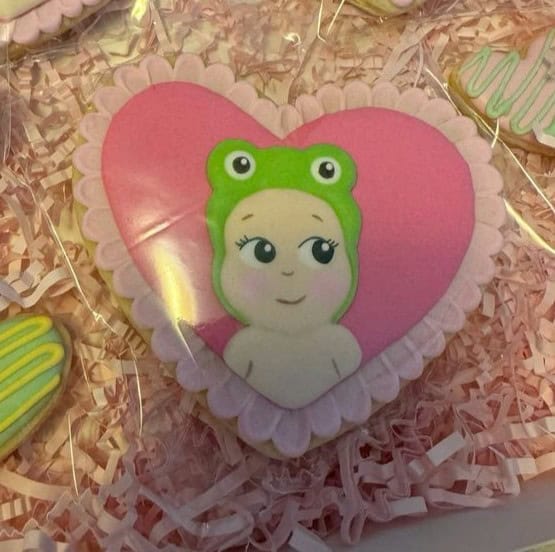 sonny angel cookies Heart-shaped cookie with cartoon baby design.