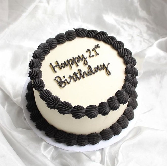 borders, writing, and beyond 21st birthday cake with black frosting