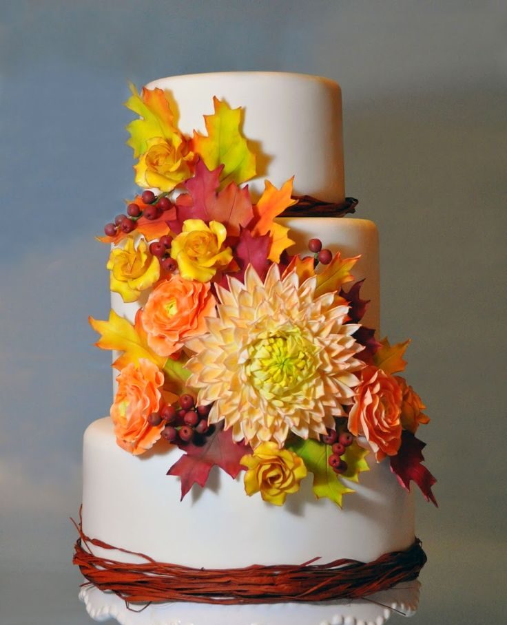f87aa469e93a2e2feed3fb5b5e4b64d7 Three-tier cake with autumn floral decorations.
