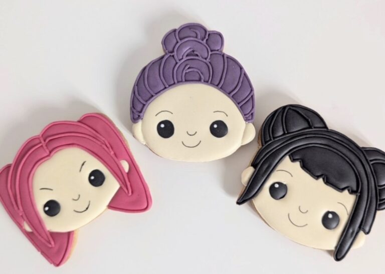 family day kpop cookies Vibrant cartoon-style girl face cookies with colorful hair and detailed frosting, perfect for cake decorating and bakery supplies at Over the Top Cake Supplies.