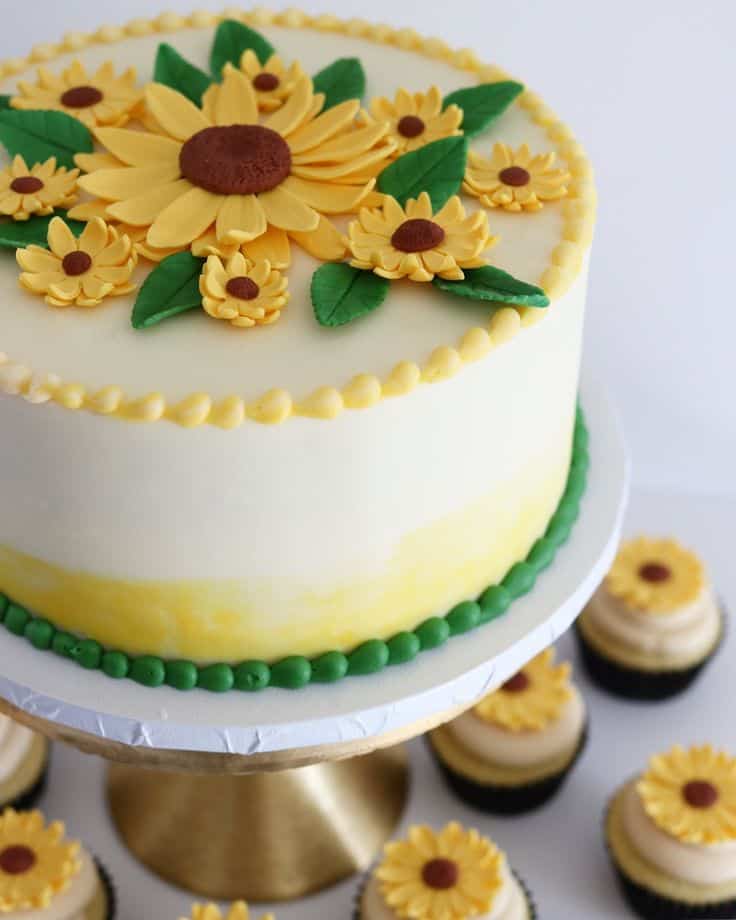 fe0ac9685195922aa08de4c82615e7ba Sunflower-themed cake with matching cupcakes.