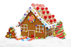 Gingerbread house decorated with colorful candies, icing, and gumdrops, perfect for holiday celebrations. Over the Top Cake Supplies offers premium cake decorating tools and supplies.