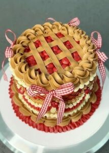 Rich chocolate and strawberry layered cake decorated with caramel-colored frosting, red ribbons, and a lattice pattern on top, perfect for celebrations and special occasions.