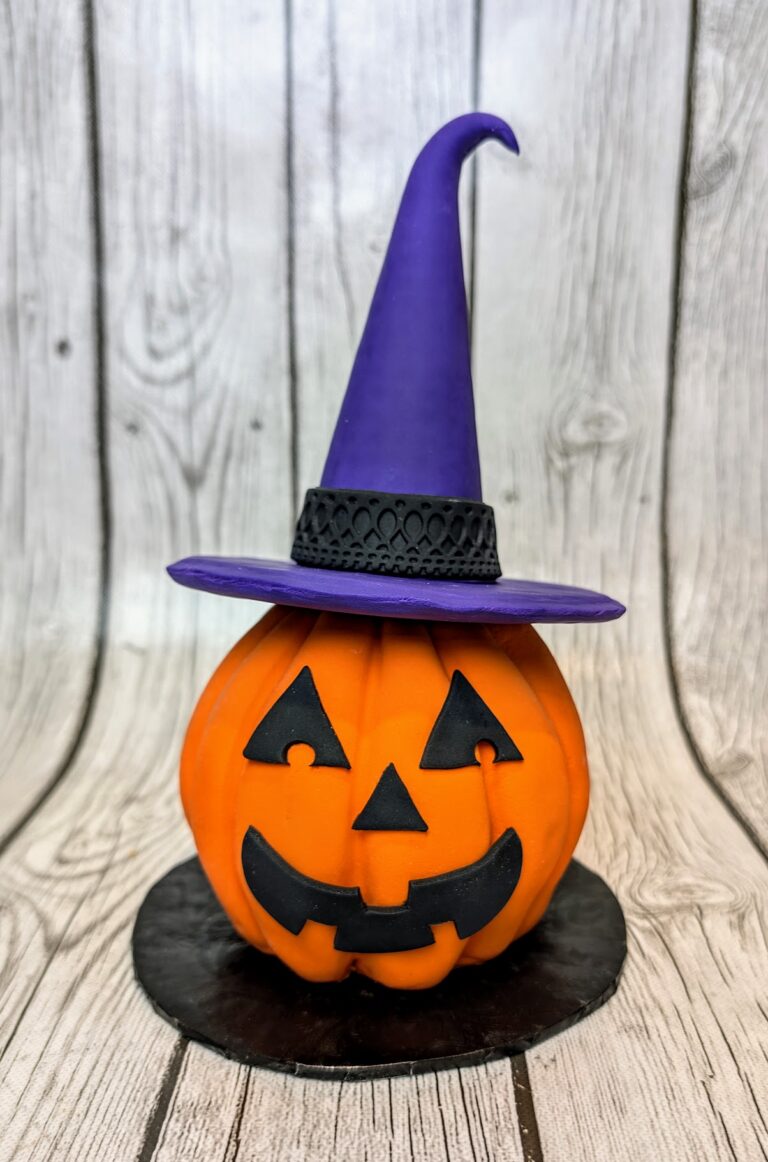 jack o lantern cake Colorful Halloween-themed pumpkin cake with a witch hat, perfect for spooky celebrations. Top-quality cake supplies for creative birthday and holiday cakes from Over the Top Cake Supplies.