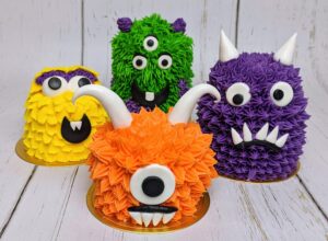Colorful monster-themed cupcakes with vibrant frosting and creative monster face decorations from Over the Top Cake Supplies. Perfect for birthday parties and special celebrations.