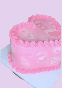 Heart-shaped cake with pink frosting, love-themed decorations, and piping detail, perfect for romantic occasions, wedding, or anniversary celebrations.