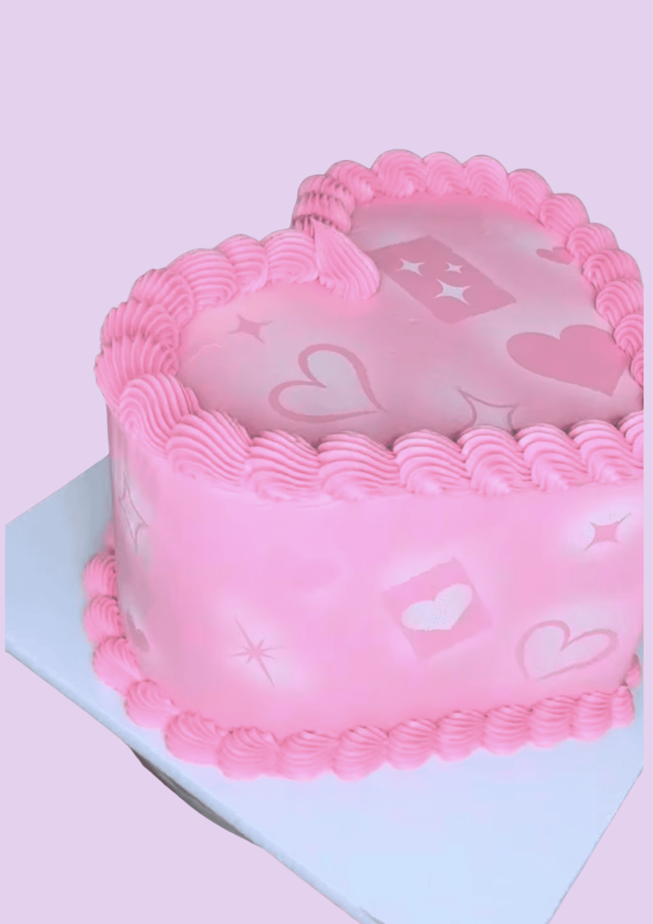 Heart-shaped cake with pink frosting, love-themed decorations, and piping detail, perfect for romantic occasions, wedding, or anniversary celebrations.