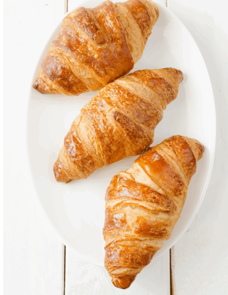 apple strip danish Buttery croissants on a white plate, perfect for bakery or cafe dessert displays. Freshly baked, flaky, golden-brown pastries ideal for breakfast or snack.