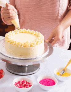 Delicious cake decorating with piping bag and frosting at Over the Top Cake Supplies, specializing in professional cake supplies, decorating tools, and edible decorations for bakers.