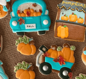 Colorful fall-themed cake cookies including pumpkins, a pumpkin patch cart, and a pumpkin truck, perfect for seasonal baking and decorating with high-quality cake supplies.