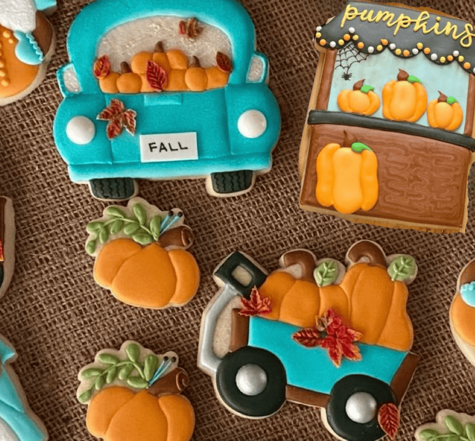 Colorful fall-themed cake cookies including pumpkins, a pumpkin patch cart, and a pumpkin truck, perfect for seasonal baking and decorating with high-quality cake supplies.