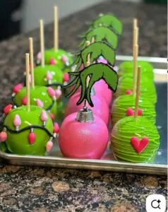 Green and pink cake pops decorated with holiday-themed embellishments from Over the Top Cake Supplies.