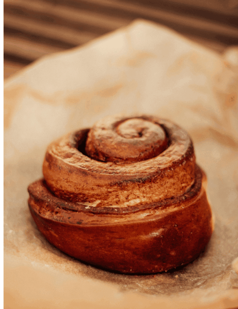 cinnamon rolls Rich cinnamon roll with swirled frosting topped with cream cheese icing, fresh from Over the Top Cake Supplies bakery, perfect for decorating and baking supplies, ideal for cake decorating enthusiasts.