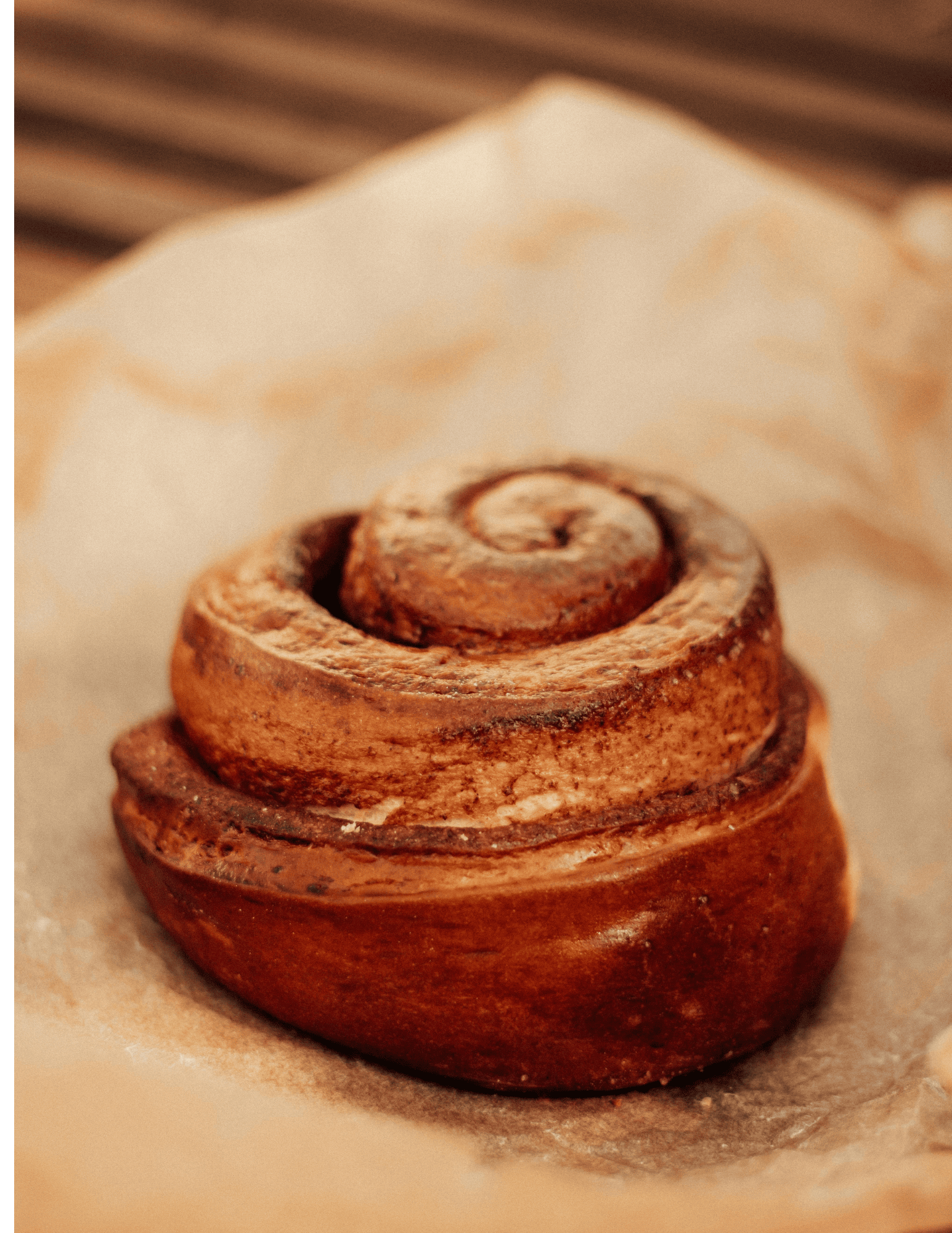 Rich cinnamon roll with swirled frosting topped with cream cheese icing, fresh from Over the Top Cake Supplies bakery, perfect for decorating and baking supplies, ideal for cake decorating enthusiasts.