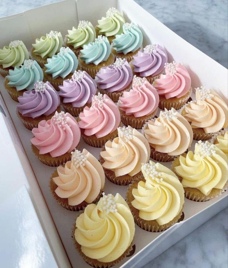 ddd08f05f47320c2aa460652086dff90 Colorful swirl cupcakes with sprinkles in pastel shades, perfect for cake decorating and bakery supplies from Over the Top Cake Supplies.