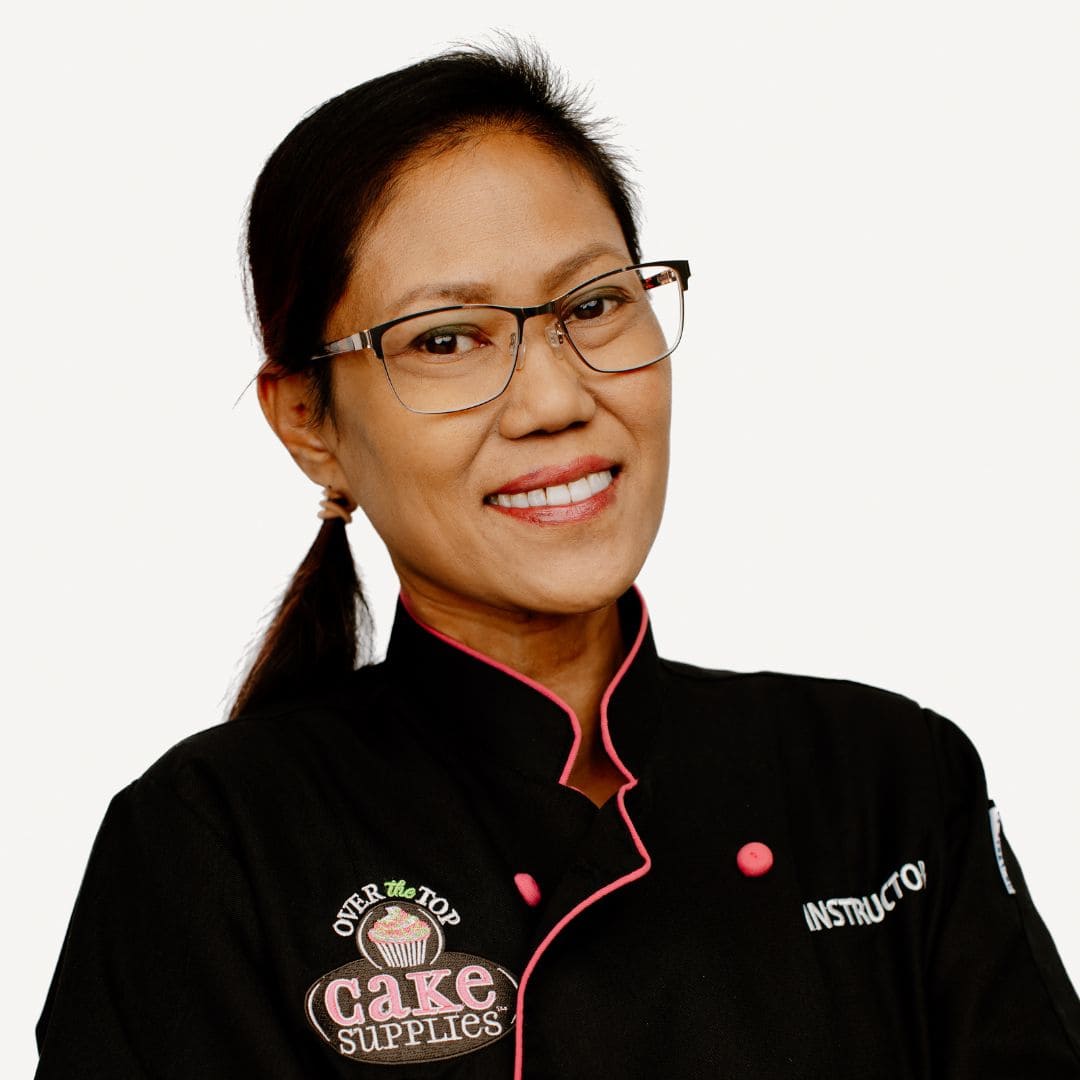 Chef with cake decorating tools and supplies at Over the Top Cake Supplies, specializing in cake decorating, baking accessories, and cake decorating classes.