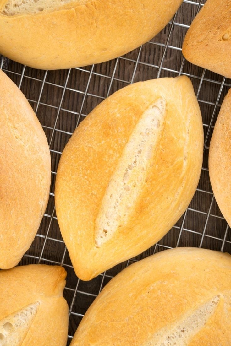 Sweet Bread Rolls for Baking. Fresh yellow bread rolls on cooling rack with a golden crust, perfect for baking and decorating. Ideal for cake decorating supplies, bakers, and dessert decorating at Over the Top Cake Supplies.