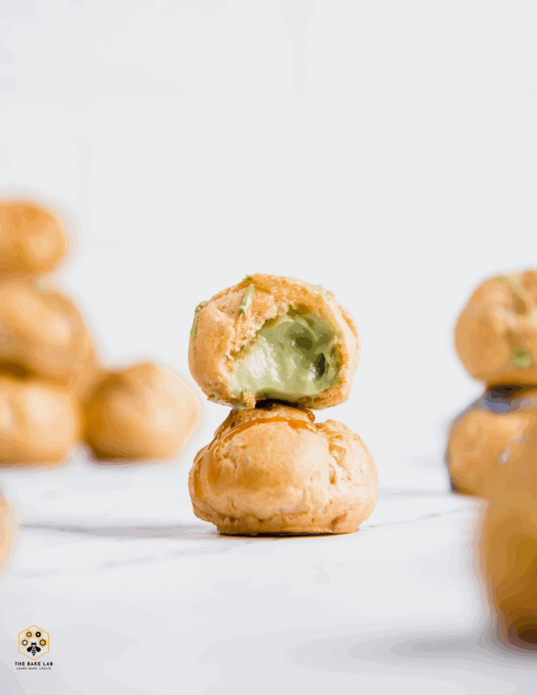 pistachio cream puffs Delicious cream-filled cake pops on white background; perfect for bakery supplies, cake decorating, and dessert tables.