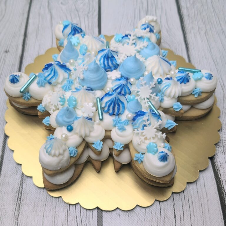 Winter themed star-shaped cake with blue and white decorating elements, perfect for holidays or special occasions, featuring buttercream, snowflake accents, and festive cake supplies from Over the Top Cake Supplies. Snowflake decorated winter cake with blue and white frosting, perfect for holiday celebrations. Features intricate icing details, festive cake toppers, and high-quality cake supplies.