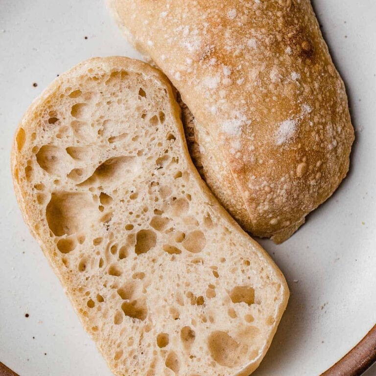 Close-up of a rustic, crusty loaf of sourdough bread, sliced to reveal airy, chewy interior, perfect for baking and cake decorating supplies.