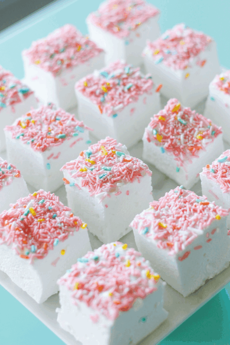 Marshmallow Treats. Delicious pink and white marshmallow treats topped with colorful sprinkles, perfect for cake decorating and party treats. Ideal for baking supplies from Over the Top Cake Supplies.