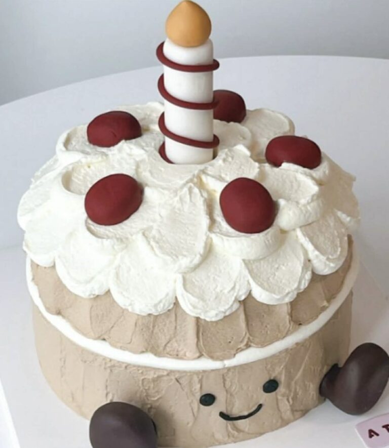 Whimsical cake with cherry topping and caramel accents, perfect for celebrations and birthday parties. Bright and colorful cake decorated with whipped cream, cherries, and a caramel candy on top, ideal for special occasions.