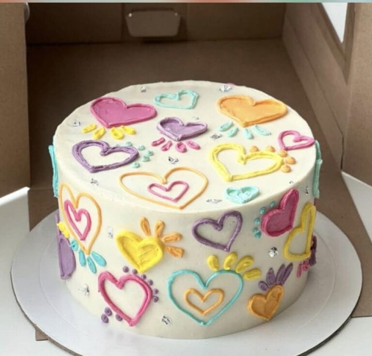 Vibrant decorated cake with colorful heart-shaped icing and sprinkles, perfect for celebrations. Crafted with premium cake decorating supplies for stunning dessert presentations.