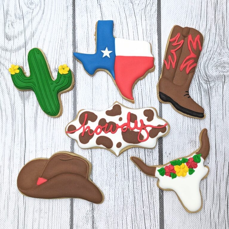 Colorful Texas-themed cookies featuring cowboy hats, cacti, a "Howdy" sign, and a cowboy boot, designed for Western and country party decor and celebrations. Each cookie is decorated with vibrant icing for a festive look.