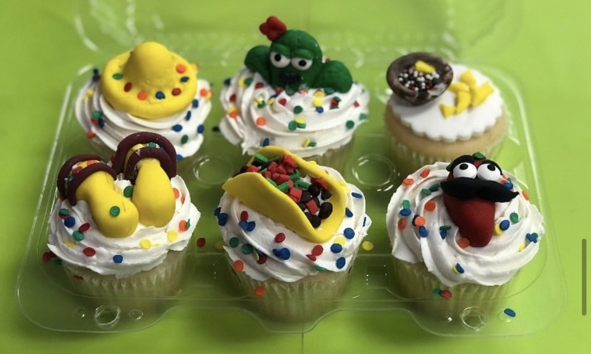 Decorative fiesta cupcakes featuring vibrant icing, playful toppers like sombreros and characters, perfect for homeschool fiesta sessions and celebrations.