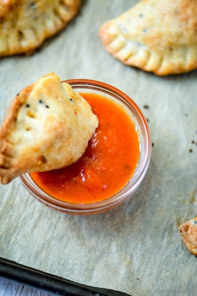 Savory Empanadas with Dipping Sauces Empanadas served with flavorful dipping sauces, perfect for appetizers or snacks. Ideal for baking and decorating with cake supplies from Over the Top Cake Supplies.