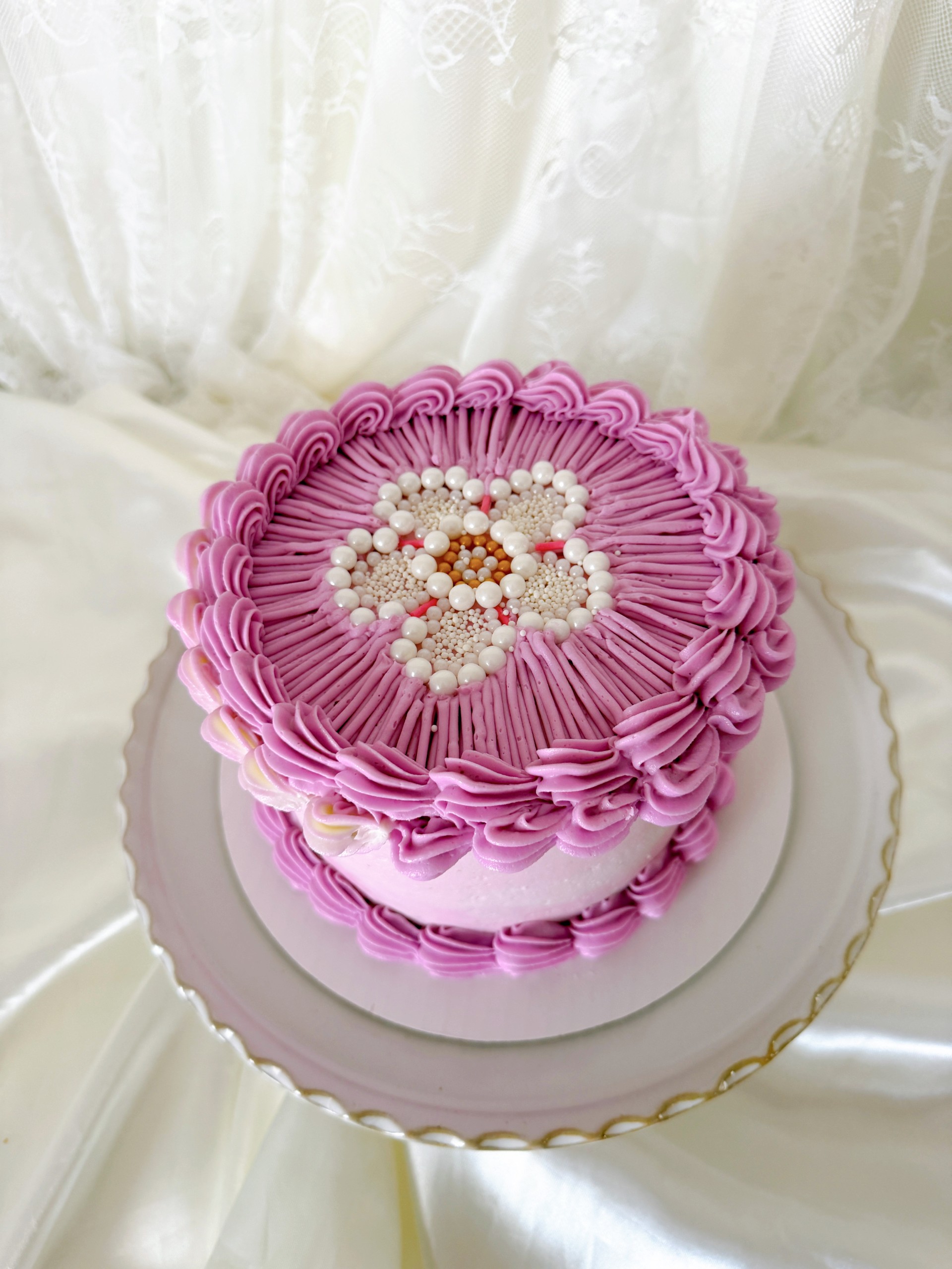 Beautiful pink embroidery-style cake decorated with colorful sprinkles and pearls, inspired by the Sprinkle Embroidery Cake with Malina from Sweet Grace Dessert Co. Perfect for celebrations.