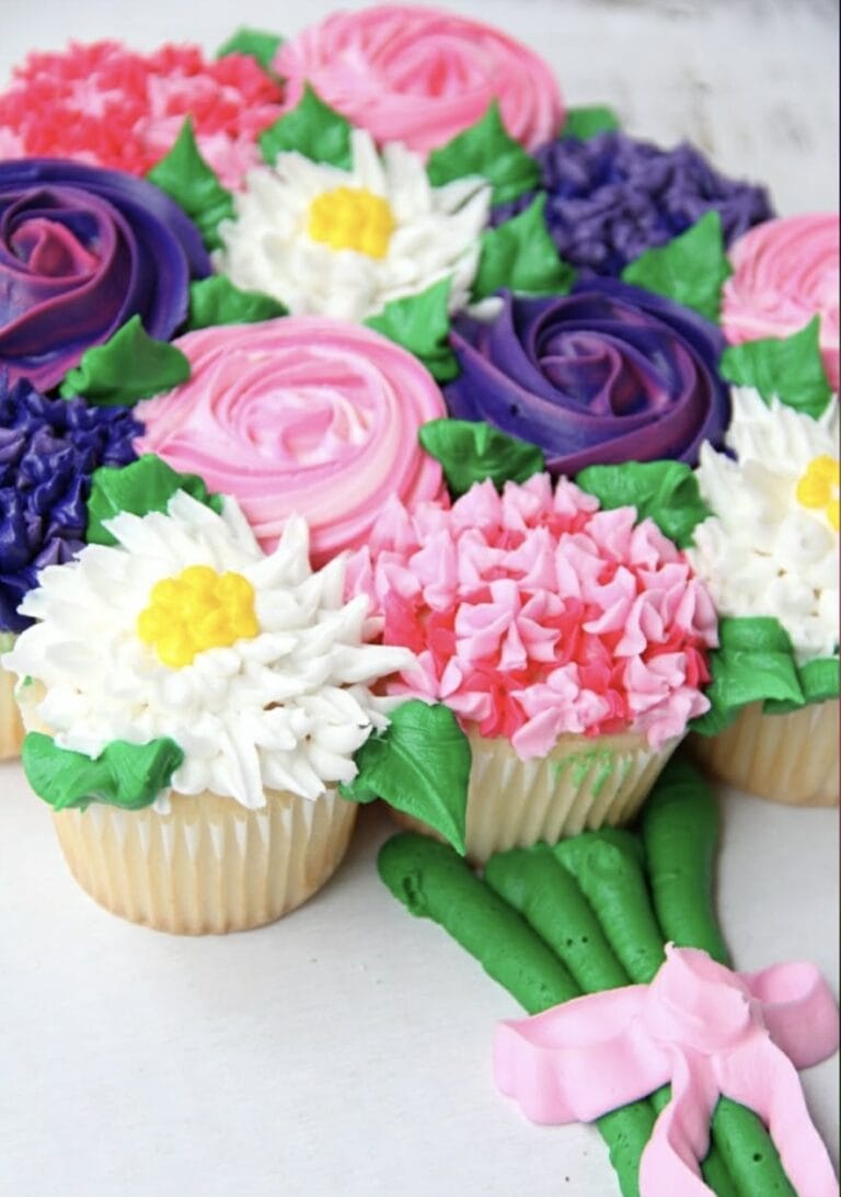 Decorative cupcake bouquet with colorful floral frosting designs for special occasions.