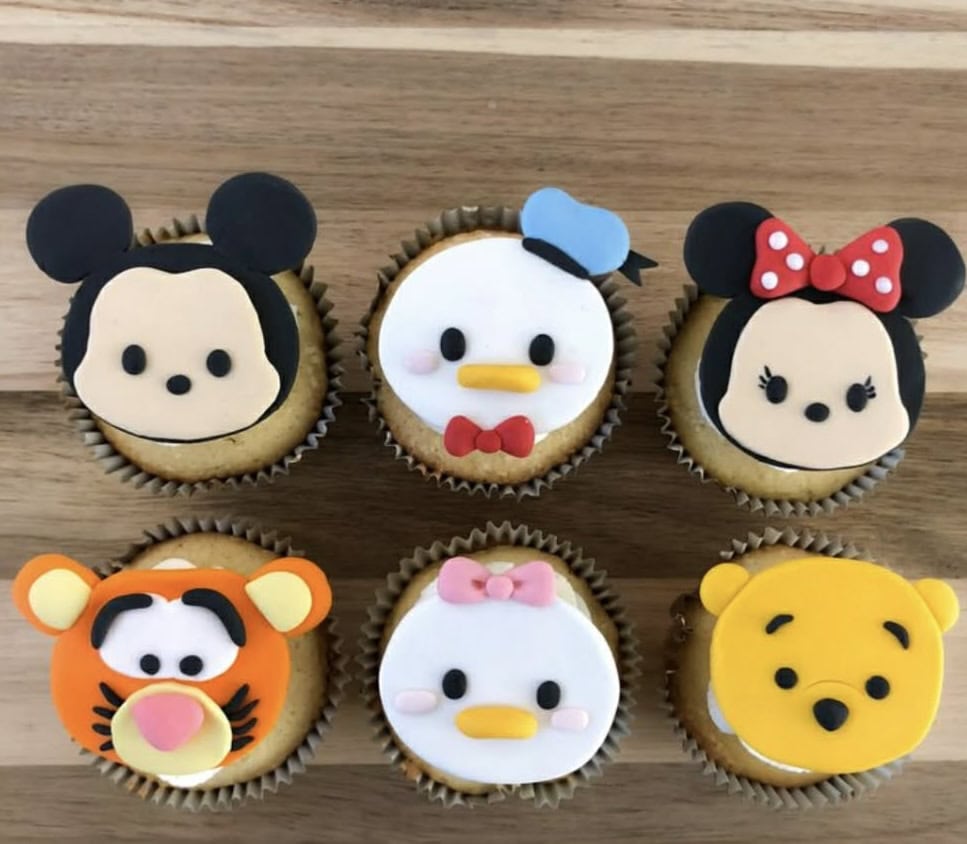 Adorable Disney-themed fondant cupcake toppers featuring Mickey Mouse, Minnie Mouse, Donald Duck, Tigger, Daisy Duck, and Winnie the Pooh, perfect for kids' birthday cakes and celebrations.