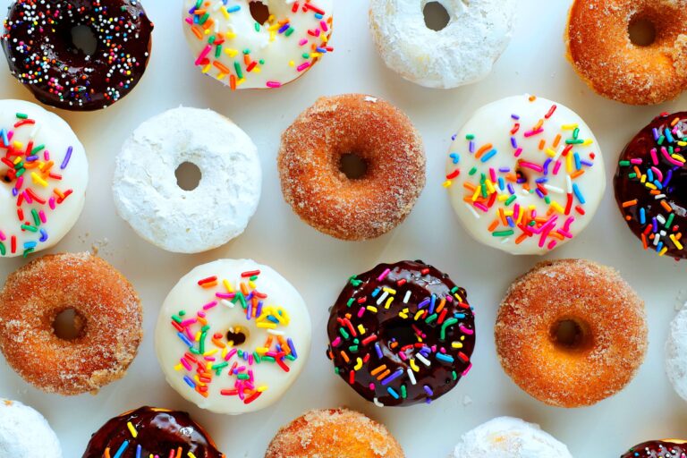 Delicious mini baked donuts decorated with colorful sprinkles, perfect for cake decorating, baking projects, and dessert presentations. Ideal for bakers seeking high-quality cake supplies.