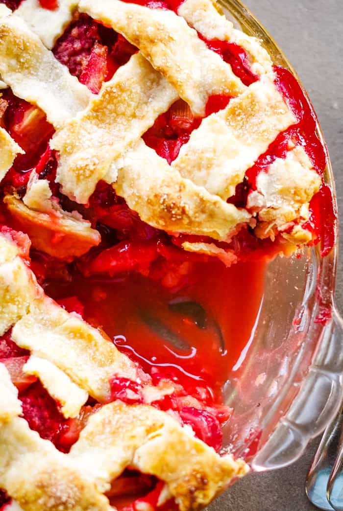 Delicious homemade strawberry rhubarb pie featuring a golden lattice crust, perfect for baking enthusiasts and cake supply shoppers.