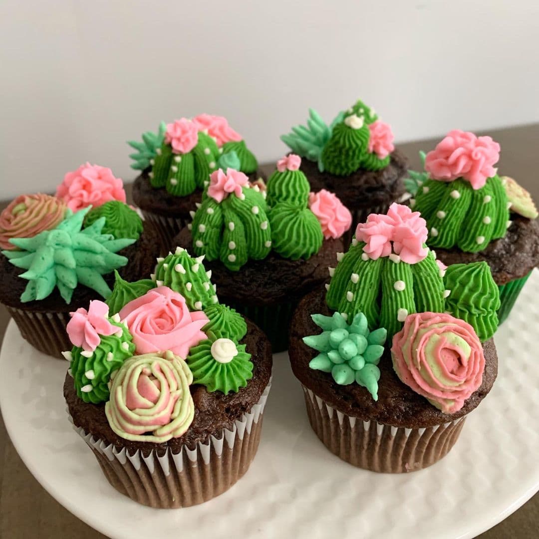 Assorted cupcakes decorated with colorful edible succulent and cactus toppers for beginner buttercream cake decorating.