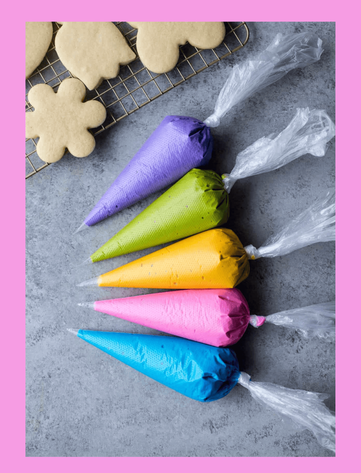 Piping bags in purple, green, yellow, pink, and blue with clear tips, used for decorating cakes and cookies.