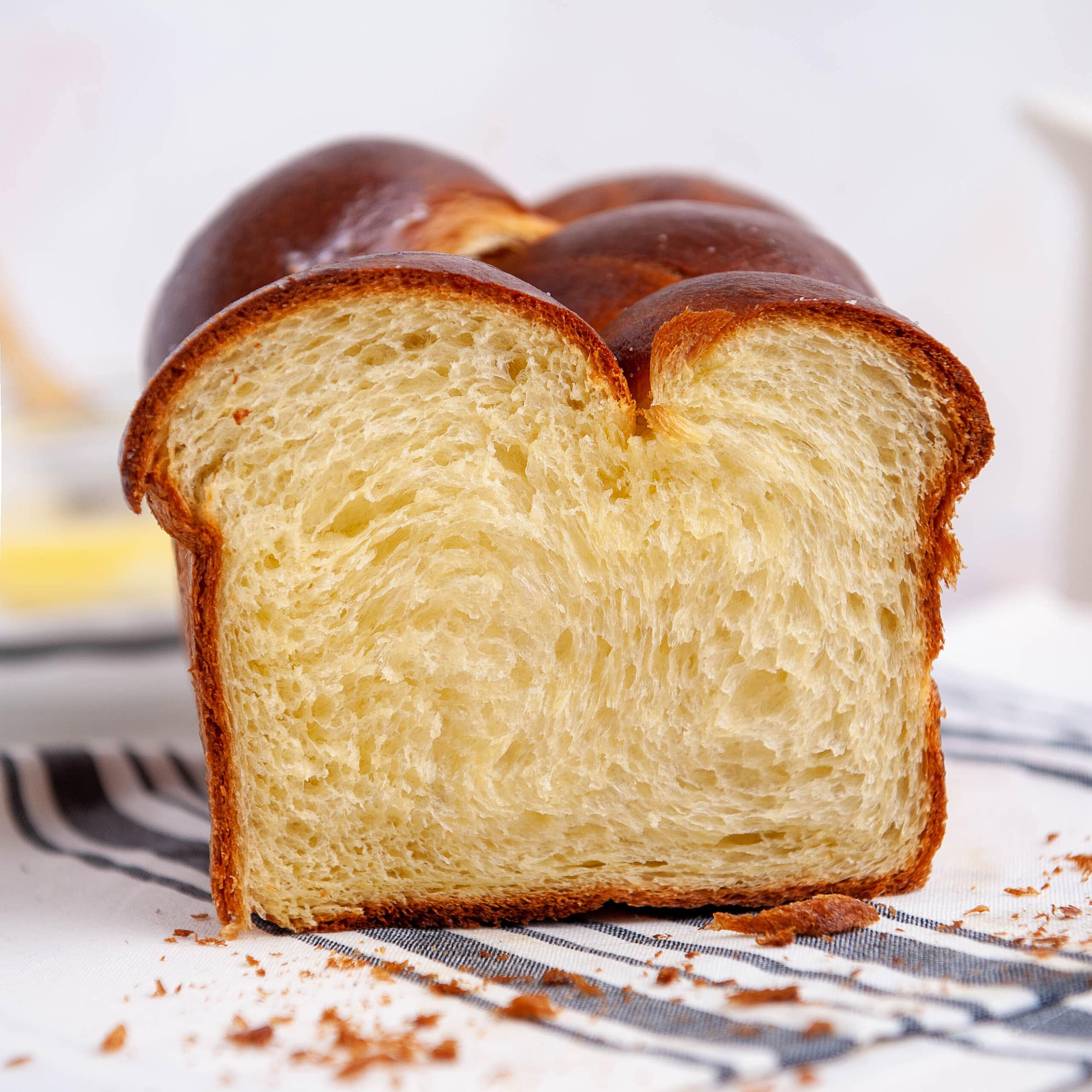 Close-up of a freshly baked soft and buttery brioche bread with a golden crust and fluffy interior, perfect for baking and bread lovers.