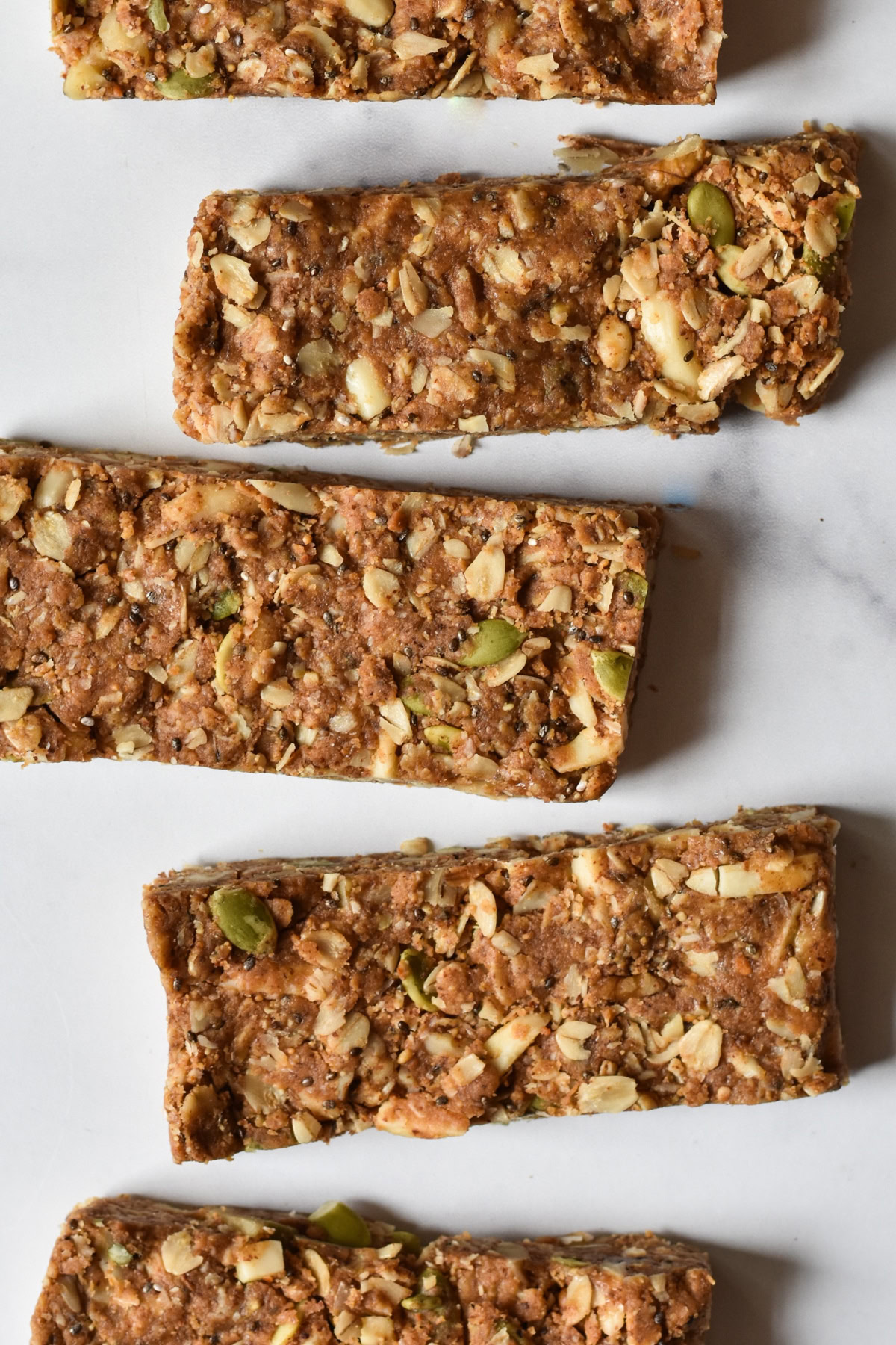 Close-up of homemade granola bars with nuts, seeds, and oats, showcasing a healthy snack option for energy and nutrition.