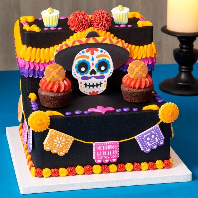 Colorful Dia de Muertos cake with sugar skull, marigolds, and festive decorations for Day of the Dead celebrations.